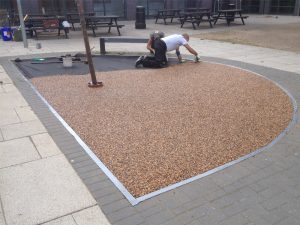 StyleSeal installer finishing a resin bound tree pit surround