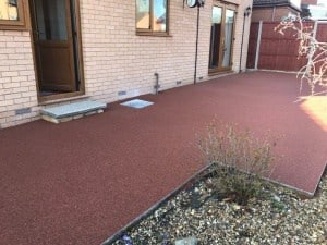 Red resin bound patio at the rear of a house