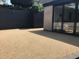 Buff resin bound patio outside a modern garden room