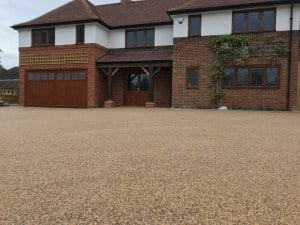 Large resin bound driveway in front of a detached brick house