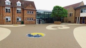 Resin bound play area at Dragon School, Oxford, with the school crest in the surface