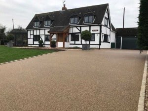Resin bound driveway in front of a black and white timber-framed house