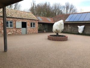 Permeable resin bound courtyard around a brick planter, Kimbolton