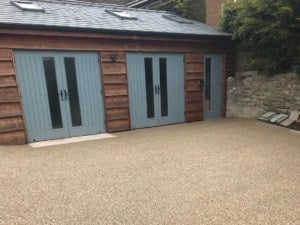 Resin bound surfacing outside a timber garage near Newent, Gloucestershire