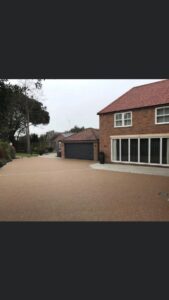 Resin bound driveway at a brick house with a double garage