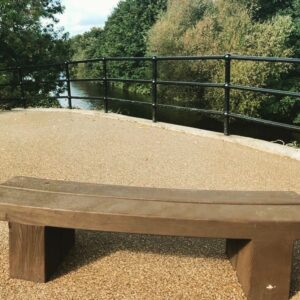 Resin bound seating area with a timber bench beside water