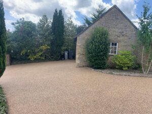 Resin bound driveway around a Cotswold stone outbuilding