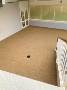 Resin bound terrace beside a pool changing area